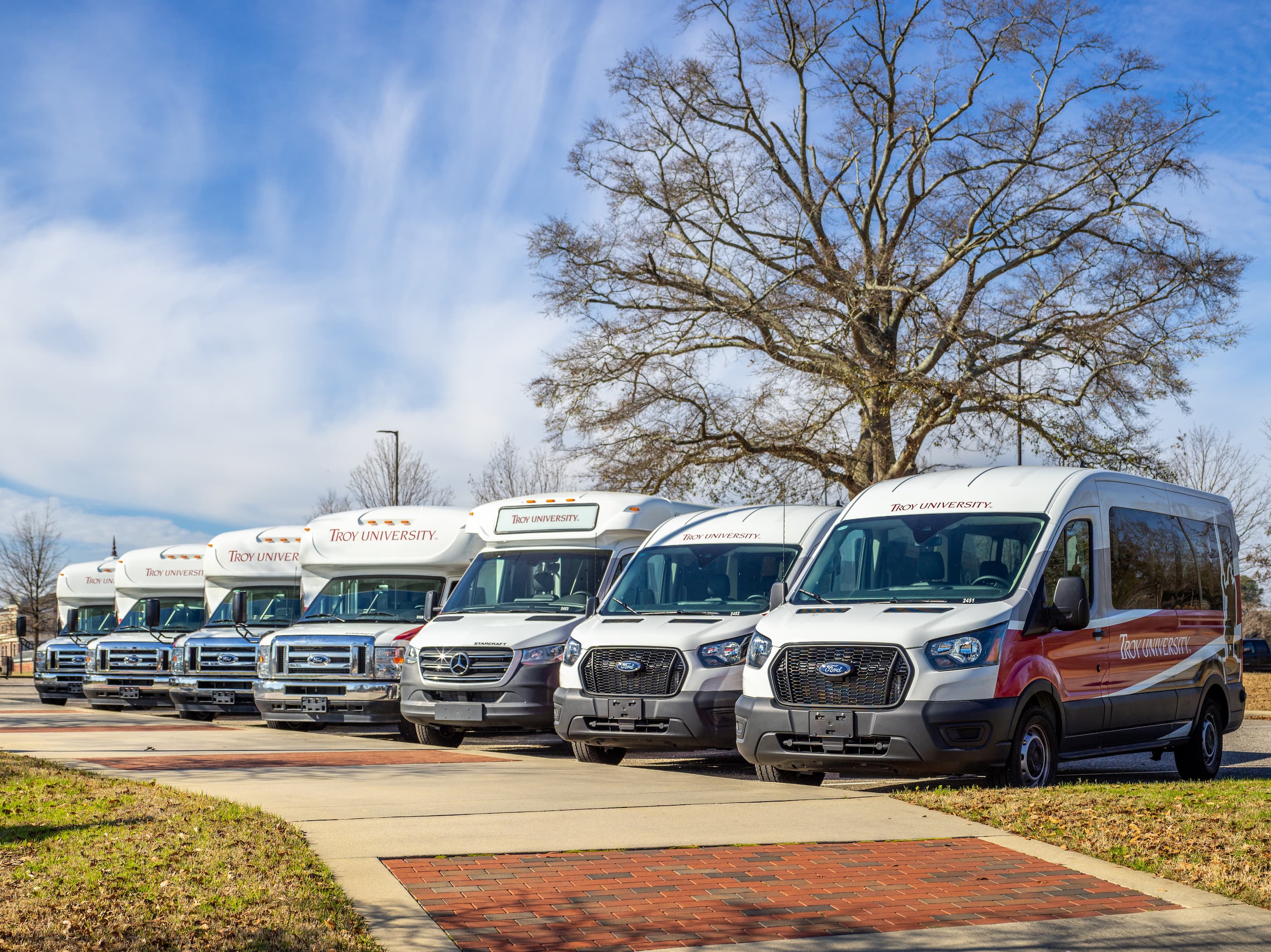 TROY's five shuttle buses and two TROY vans.